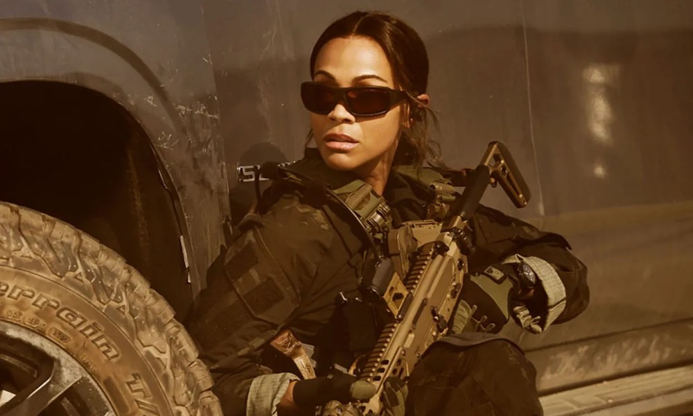 Zoe Saldana holds a gun in Lioness.